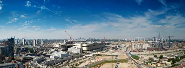 "Panoramic view of a huge construction site in Stratford, London. This development is part of the regeneration plan for the east of the capital in preparation for the London 2012 Summer sporting event. Familiar landmarks like Canary wharf, 'The Gherkin' and the Post Office Tower can be seen on the horizon."