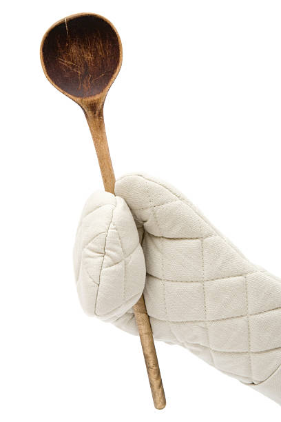Oven mitt and old-fashioned spoon. White background.