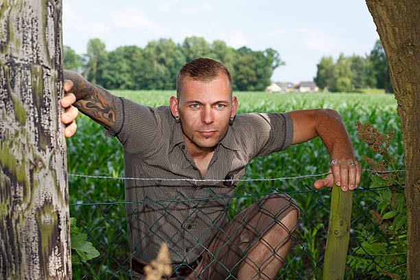 istock Smiling Man At A Fence 182843873