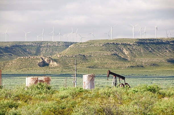 istock Oil Pump Jack and Wind Turbines 182844397