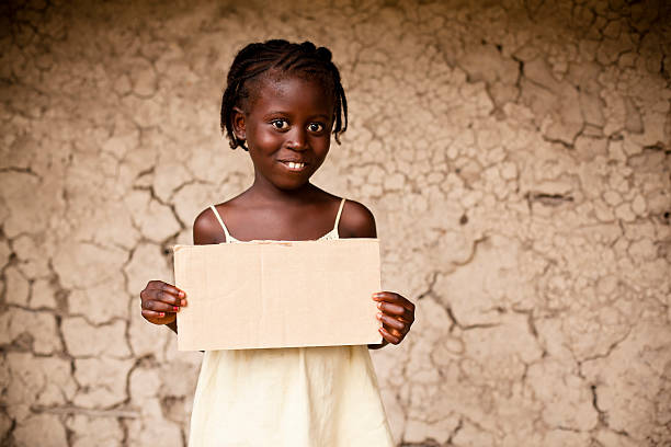 istock African Girl Holding a Blank Sign 182844597