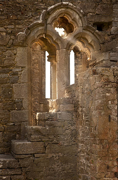 istock Medieval Irish Church Ruin Window and Sunbeams 182844637