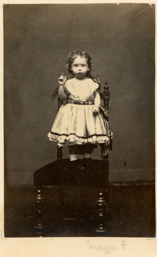 Vintage photograph taken circa 1870 of a young Victorian Little Girl stood on a chair