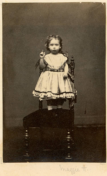Victorian Little Girl Vintage photograph taken circa 1870 of a young Victorian Little Girl stood on a chair horror photos stock pictures, royalty-free photos & images