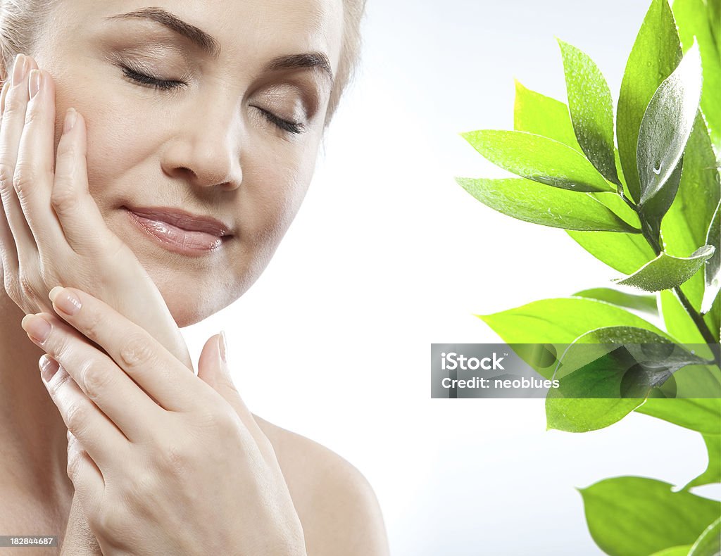 Facial massage of woman with  green leaf 35-39 Years Stock Photo