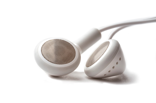 Close up photo of white headphones on a white background.