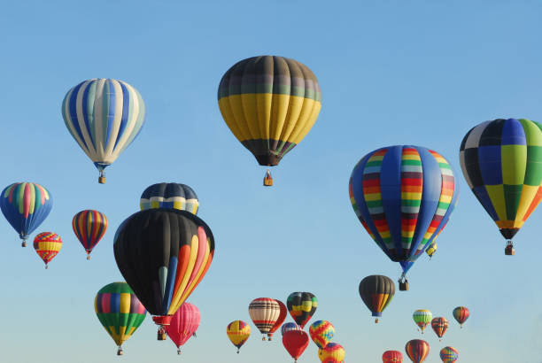 Many multicolored hot air balloons in the clear blue sky stock photo