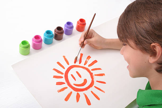 istock Schoolboy Painting A Sun 182845438