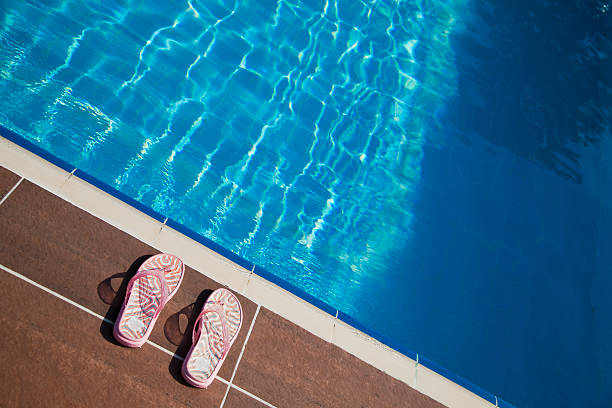 istock Slippers lies on the brink Pool 182846042