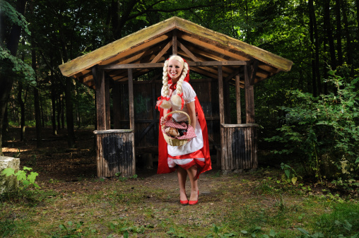 Cheerful Little Red Riding Hood Showing Her Basket
