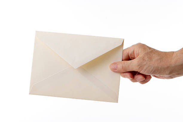 Holding an old envelope isolated on white background.