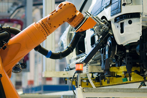 Automobile Industry Robot in an Automobile Industry production line automobile industry car plant car stock pictures, royalty-free photos & images