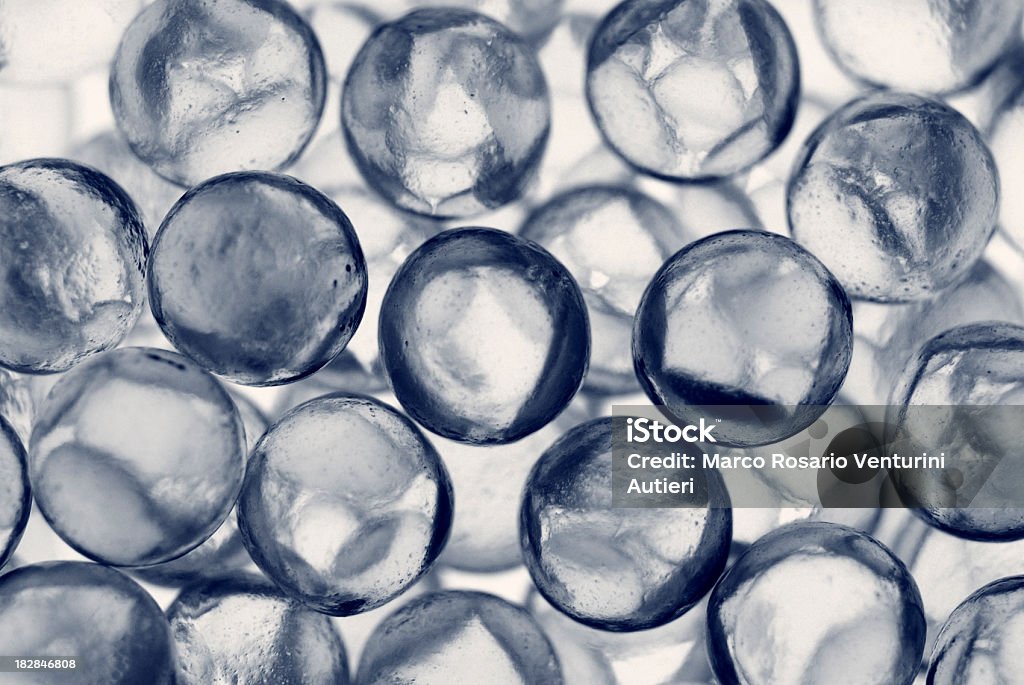 Small glass spheres, textured background, transparent Macro photography of small glass spheres. Each measures about 3 mm in diameter, so the irregularities in the surface are plainly visible in this enlargement. Toned. AdobeRGB Bead Stock Photo