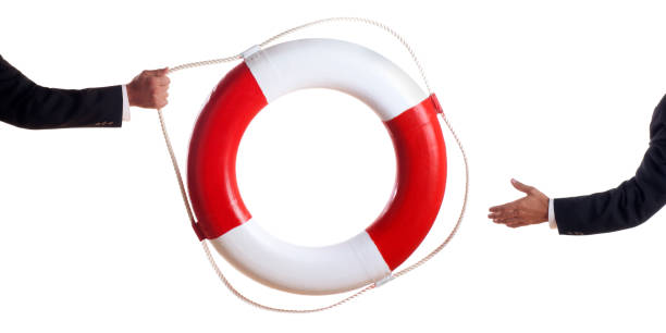 biznes człowiek podrzucając w life preserver - life jacket isolated red safety zdjęcia i obrazy z banku zdjęć