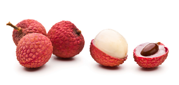 Set of flying lychee fruits isolated on white background.
