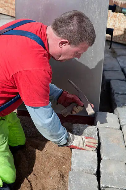 "Paver working on his knees setting granite paving stones, Stockholm, Sweden.See also my LB:"