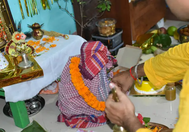 Photo of A priest in the Hindu god Hanuman temple at home. Selective focus.