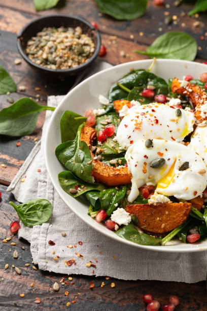 istock Roasted butternut squash salad served with poached eggs, spinach, nuts and pomegranate seeds 1828492432