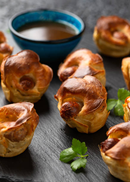 istock Mini Toad in the hole, Baked sausages in Yorkshire pudding with gravy 1828492974