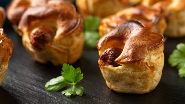 istock Mini Toad in the hole, Baked sausages in Yorkshire pudding with gravy 1828493507
