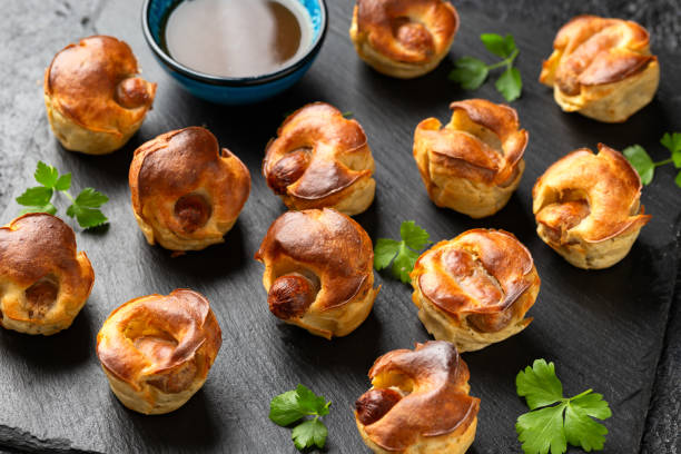 istock Mini Toad in the hole, Baked sausages in Yorkshire pudding with gravy 1828493511
