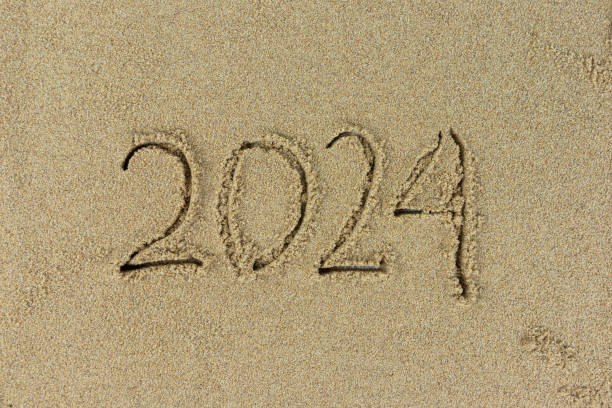 istock Handwritten 2024 on clean beach sand. Happy New Year 1828493548
