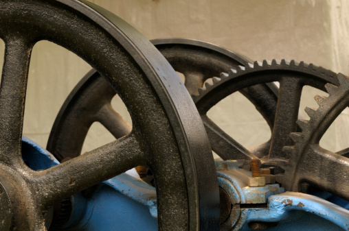 Close up of some industrial equipment showing steel wheels and gears.