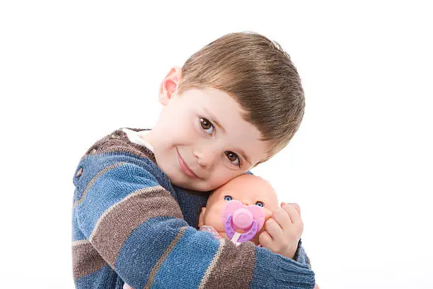 Photo of Boy hugging a doll