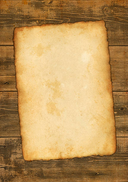 istock old paper with burned edges on wooden background 182851201