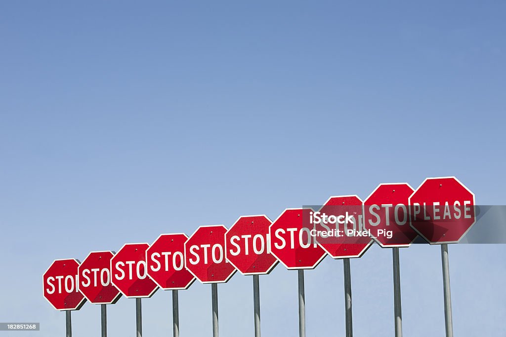 Row of Stop Signs 2 Stop ... please Blue Stock Photo