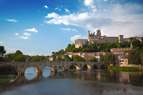 St. Nazaire, Beziers, France "The ancient church of St. Nazaire in Beziers, France - overlooking view of the ancient bridge and a beautiful blue sky." loire atlantique photos stock pictures, royalty-free photos & images