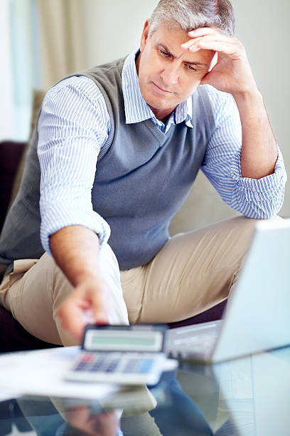 istock Mature man worried about paying his bills 182851990