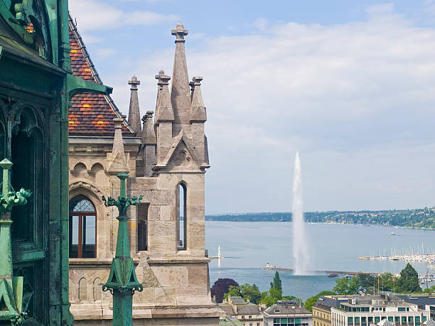 Cathedral Saint Pierre in Geneva, Switzerland. View from above on copper tower and lake with fountain.