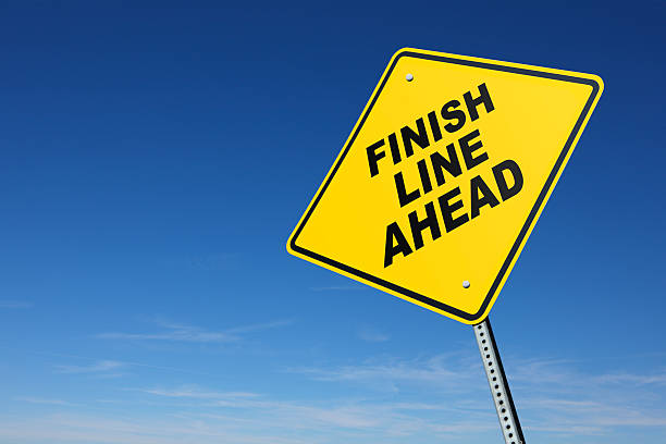 istock Finish Line Ahead on yellow road sign 182853304