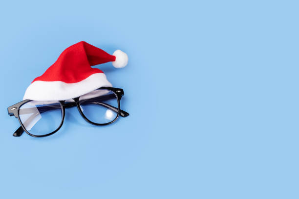 istock Glasses in santa hat, optics. Eyewear health, vision correction, copy space 1828536480