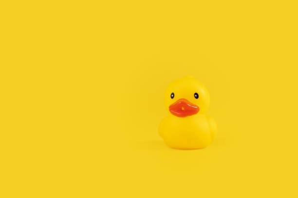 istock rubber duck on yellow background, bath relaxation, cute duckling, bathroom fun 1828536482