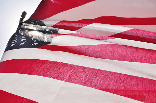 istock American Flag with sun shining through 182854345