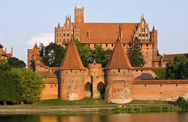 Medieval Malbork castle on the river Nogat, Poland "The Castle in Malbork - Capitol of the Teutonic Order of Crusaders, PolandSee more HISTORICAL BUILDINGS images here:" malbork photos stock pictures, royalty-free photos & images