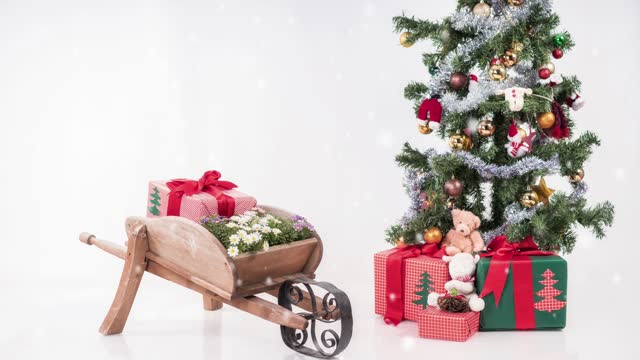 Red and Gold Decorated Christmas Tree and wooden wheelbarrow loaded with Christmas  gifts.