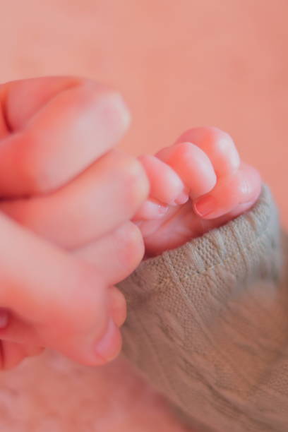 istock Young Woman Holding Baby's (Reborn Doll) Hands 1828545636