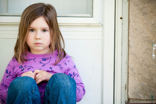 Color photo of a little girl giving a look of disapproval.
