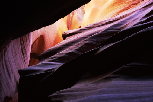 Antelope canyon sandstone rock formation abstract with sunlight filtering through slot walls.