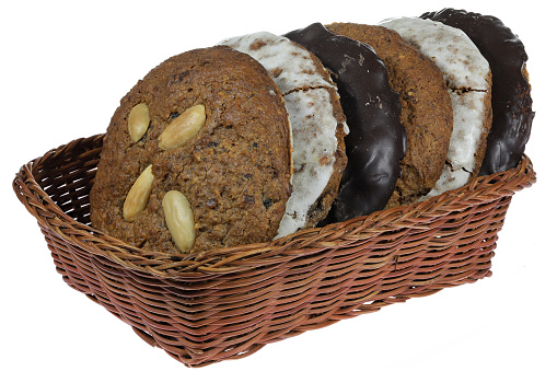 Original Nuremberg Elisen type Lebkuchen (gingerbread) in a basket isolated on white background. Nuremberg is a city in Germany and well-known for its gingerbread skilled crafts and trades.