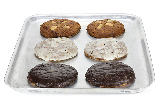 Original Nuremberg Elisen type Lebkuchen (gingerbread) on a baking plate isolated on white background. Nuremberg is a city in Germany and well-known for its gingerbread skilled crafts and trades.