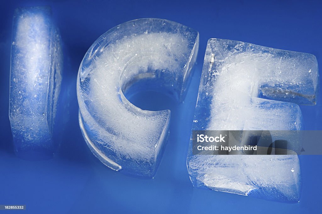 Ice on Blue Letters from Ice Carved to spell word Ice on a blue background Alphabet Stock Photo