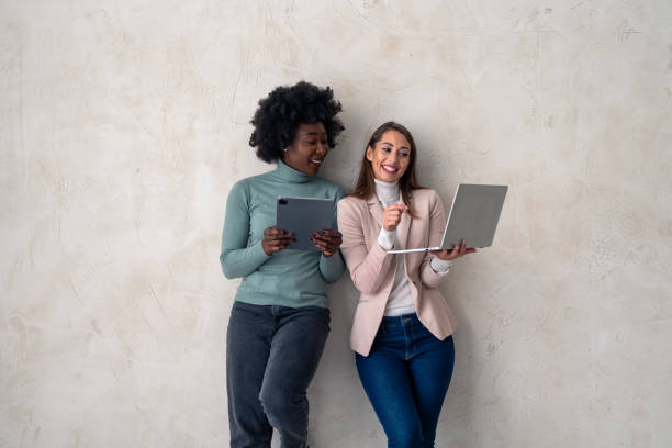istock Two interracial businesswomen working on laptop and digital tablet 1828554712