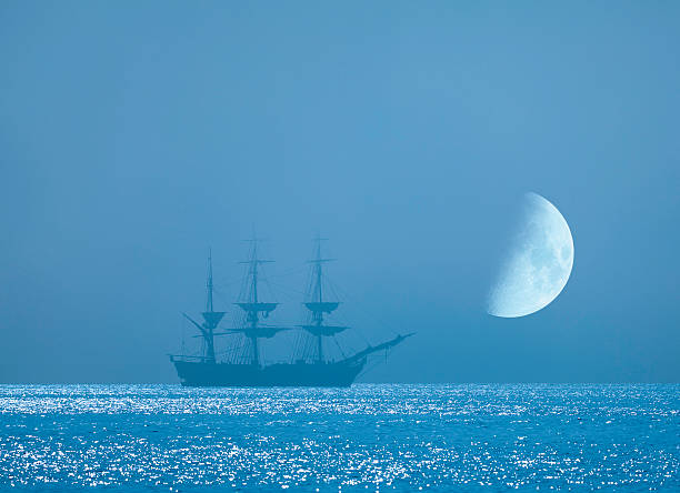 istock Distant Tall Ship Anchored Beneath Rising Moon 182855516