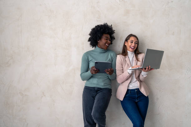 istock Two diverse females working on digital technology in a studio 1828555233
