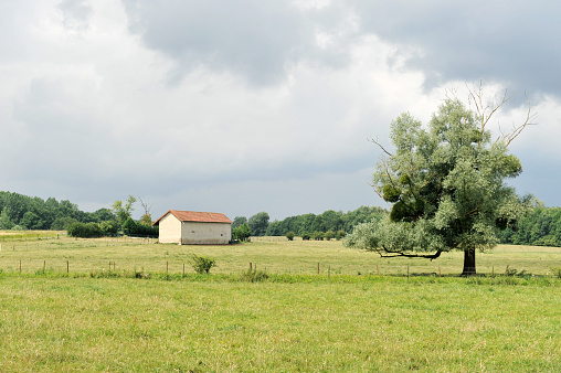 Rural landscape with barn in France.