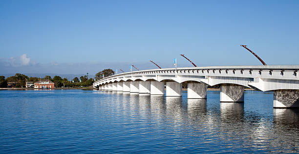 istock Modern white bridge over water sea with blue sky 182856257